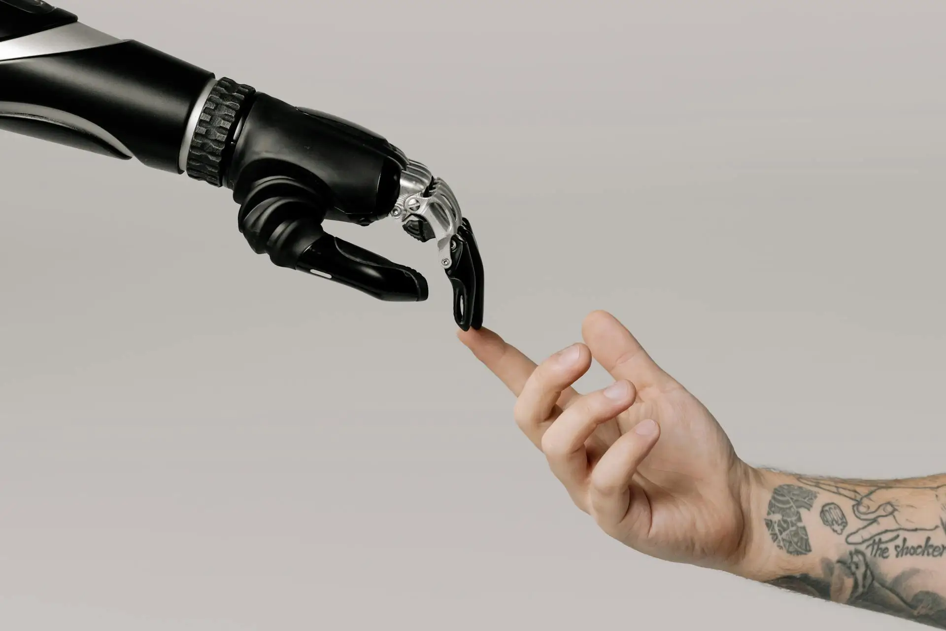Exploring Web Design and Development in the Age of AI Human and a robot arm touching finger tips.